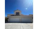 Two-story home featuring a three-car garage and a terracotta-tile roof at 1003 Dover Glen Dr, North Las Vegas, NV 89031