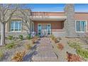 Inviting front entrance with stone pathway, desert landscaping, and decorative stone accents at 10150 Emerald Sunset Ct, Las Vegas, NV 89148