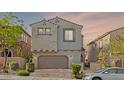 Charming home featuring a stucco exterior, a brick driveway, tile roofing, and an attached two-car garage at 10468 Skye Knoll Ave, Las Vegas, NV 89166