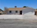 Single-story home featuring a low-maintenance rock garden and an attached two-car garage at 1075 Greymouth St, Las Vegas, NV 89110