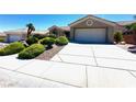 Inviting one-story home with a spacious driveway and tidy landscaping at 11025 Hawk Valley Ave, Las Vegas, NV 89134