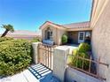 Welcoming front gate and courtyard with stucco walls create an intimate entrance to the property at 11025 Hawk Valley Ave, Las Vegas, NV 89134