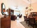 Cozy living and dining area with a ceiling fan, tile floors, and bright natural light at 11025 Hawk Valley Ave, Las Vegas, NV 89134