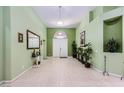 Bright foyer with tile flooring, high ceilings, decorative lighting, and neutral wall color at 11253 Sanbury Brook St, Las Vegas, NV 89183