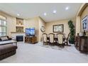 Spacious living room with tile flooring, fireplace, recessed lighting, and a cozy seating area at 11253 Sanbury Brook St, Las Vegas, NV 89183