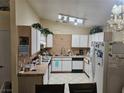 Functional kitchen with white appliances, tile countertops, and ample cabinet space at 1821 Windy Gap St, Las Vegas, NV 89106