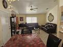 Inviting living room with comfortable seating, tile flooring, and neutral-toned walls at 1821 Windy Gap St, Las Vegas, NV 89106
