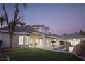 Expansive backyard with manicured lawn, rock water feature, and covered patio, ideal for outdoor living at 1865 Woodhaven Dr, Henderson, NV 89074