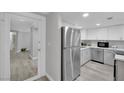 Open-concept kitchen with stainless steel refrigerator and clean, white cabinetry at 2080 Karen Ave # 1, Las Vegas, NV 89169