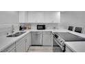 Modern kitchen featuring stainless steel appliances, white cabinets, and light countertops at 2080 Karen Ave # 1, Las Vegas, NV 89169
