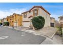 Street view of a charming two-story home showcasing stucco, shutters, and a well-kept yard in a residential area at 2130 Trebbiano Way, Las Vegas, NV 89156