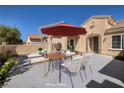 The patio features comfortable seating and an umbrella-covered table, perfect for outdoor entertaining and relaxation at 2219 Sawtooth Mountain Dr, Henderson, NV 89044