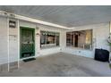 Covered carport featuring a green front door and large windows showcasing the home's interior at 2325 Sombrero Dr, Las Vegas, NV 89169