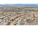 Wide aerial shot of the beautiful neighborhood nestled in the desert mountains at 2571 Thatcher Ave, Henderson, NV 89052