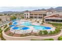 Stunning resort-style pool with ample seating, umbrellas, and a beautiful building backdrop at 2571 Thatcher Ave, Henderson, NV 89052