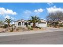 Inviting single-story home with a two-car garage, desert landscaping, and mature palm trees at 2862 Sapphire Desert Dr, Henderson, NV 89052