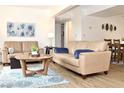 Bright living area with tan sofas, wood-look floors, and an open floor plan at 3740 Desert Marina Dr # 11, Laughlin, NV 89029