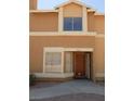 Inviting entrance to stucco townhome with an open door, security windows, and covered porch at 3890 Terrazzo Ave, Las Vegas, NV 89115