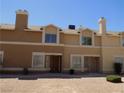 Two-story townhome with stucco and large windows, offering a comfortable living space at 3890 Terrazzo Ave, Las Vegas, NV 89115