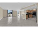 Spacious living area with tile floors, lots of natural light, and a kitchen bar at 3930 University Center Dr # 202, Las Vegas, NV 89119