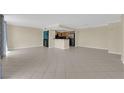 Open-concept living room with tile floors and an adjoining kitchen area at 3930 University Center Dr # 202, Las Vegas, NV 89119
