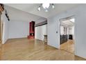 Spacious living room with hardwood floors, a red-brick fireplace, and ample natural light at 4237 Brockton Green Ct, Las Vegas, NV 89110