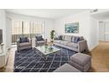 Living room boasts large windows, plush seating, and stylish decor at 5241 Caspian Springs Dr # 103, Las Vegas, NV 89120