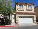 Two-story home with a two-car garage, desert landscaping, and a charming front entrance at 5286 Monterey Park Cir, Las Vegas, NV 89146