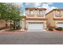 Two-story home with a terracotta roof, two-car garage, neutral stucco, and drought-resistant landscaping at 5286 Monterey Park Cir, Las Vegas, NV 89146