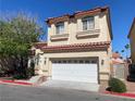 Two-story home with a two-car garage, desert landscaping, and a charming front entrance at 5286 Monterey Park Cir, Las Vegas, NV 89146
