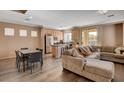 Open-concept living area with modern furnishings, seamlessly connecting the kitchen, dining, and lounge spaces at 5524 Overlook Valley St, North Las Vegas, NV 89081