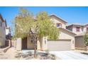 Two-story home with a two-car garage, desert landscaping and inviting front entrance at 5638 Jelsma Ave, Las Vegas, NV 89141