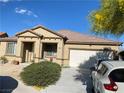 Charming single-Gathering home featuring desert landscaping, a neutral color scheme, and an attached two-car garage at 5832 Elphin Ct, North Las Vegas, NV 89031