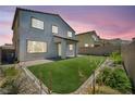 Well-manicured backyard with a covered patio and lush artificial grass at 637 Our Heritage St, Henderson, NV 89011