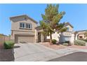 Inviting two-story home features a neutral color, landscaped front yard, and spacious driveway at 672 Peach Coral St, Las Vegas, NV 89183