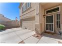 View of the front entrance with a two-car garage and landscaped front yard at 672 Peach Coral St, Las Vegas, NV 89183