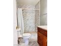 Cozy bathroom featuring a tiled shower, granite vanity and marble tile flooring at 6786 Grandola Dr, Las Vegas, NV 89103