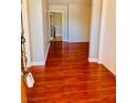 Inviting entryway with wood laminate flooring, neutral walls, and white trim at 6786 Grandola Dr, Las Vegas, NV 89103