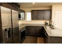 This contemporary kitchen features stainless steel appliances and plenty of cabinet space at 6824 Satin Silver Ct, North Las Vegas, NV 89086