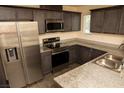 Well-equipped kitchen with stainless steel appliances, granite counters, and ample cabinet space at 6824 Satin Silver Ct, North Las Vegas, NV 89086