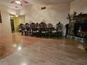 Spacious dining room featuring wood floors, stone fireplace, vaulted ceilings and natural light at 7104 Carrondale Way, Las Vegas, NV 89128