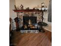 Elegant stone fireplace with decorative mantle and hearth, a focal point of the living space at 7104 Carrondale Way, Las Vegas, NV 89128