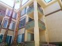 Multi-story complex displays numerous windows and balconies, surrounded by tall palm trees and ground-level foliage at 7147 S Durango Dr # 211, Las Vegas, NV 89113