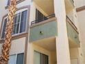 A close exterior showcases a unit's architecture, highlighting windows, small balconies, and neutral color scheme at 7147 S Durango Dr # 211, Las Vegas, NV 89113