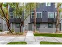 Well-maintained townhouse exterior with green turf, trees, and neutral paint scheme at 9050 W Tropicana Ave # 1053, Las Vegas, NV 89147