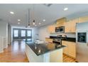 Modern kitchen featuring stainless steel appliances, a black countertop island, and light wood cabinetry at 9050 W Tropicana Ave # 1053, Las Vegas, NV 89147