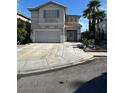 Charming two-story home boasts a large garage, desert landscaping, and a red-tile roof under a bright blue sky at 9641 Windborne Ave, Las Vegas, NV 89147
