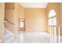 Spacious living room with high ceilings, large windows, and neutral tones, offering great natural light at 9704 Falling Star Ave, Las Vegas, NV 89117