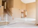Open living space with stairs, bright tiles, and warm neutral paint colors creating an airy atmosphere at 9704 Falling Star Ave, Las Vegas, NV 89117