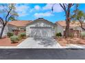 Single-story home featuring a two-car garage, desert landscaping, and a classic facade at 9962 Catalina Canyon Ave, Las Vegas, NV 89147